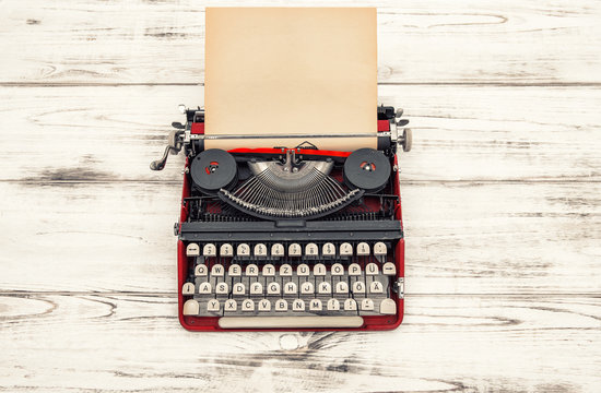 Old typewriter on wooden table. Antique object. Vintage style