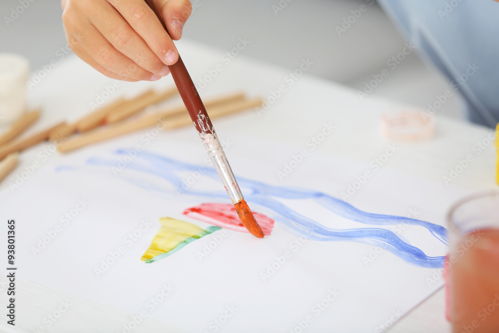 Cute little boy painting picture, close-up
