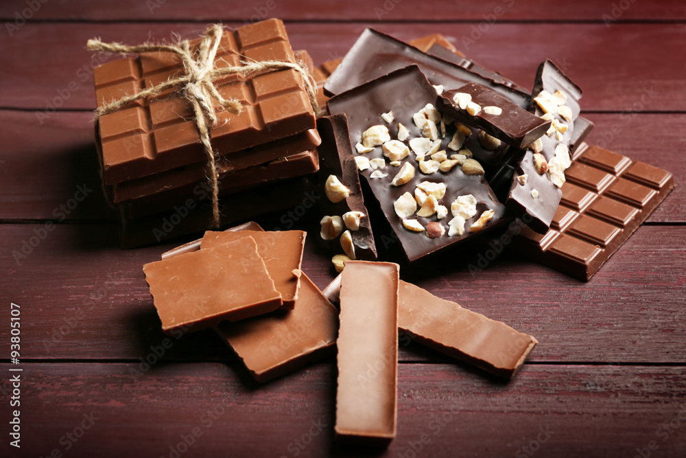 Variety of chocolate pieces on wooden background