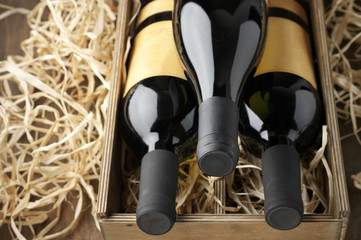 Wall Mural - Wine bottles in wooden box and straw