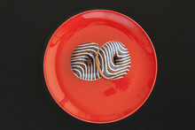 Donut Colored Zebra On The Red Plate Number Eight. Top View. Space For Inscriptions.