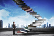 © Leo Lintang - Business person step up flying book that look like stair
