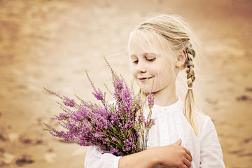 Young Girl with Flowers on Heather Moorland