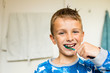 © Mikkel Bigandt - Young boy brushing his teeth with toothbrush