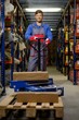 © Nejron Photo - Loader using hand pallet truck in a warehouse