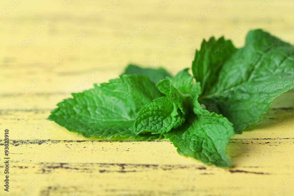 Bunch of mint on yellow wooden background
