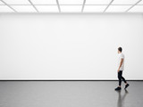 Fototapeta  - Young man walking in the empty gallery