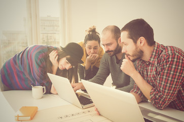 Wall Mural - Young group of people/architects discussing business plans.