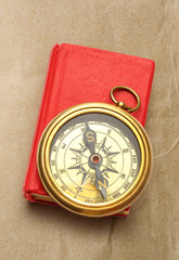 Wall Mural - Red closed book with retro compass