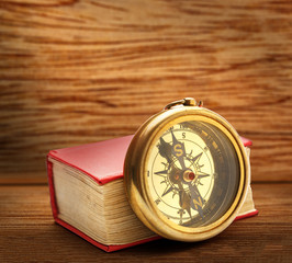 Wall Mural - Red closed book with retro compass