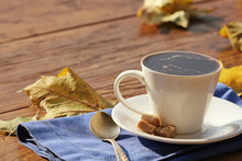 Coffee Cup On A Wooden Background In Fall Time