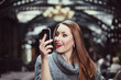 Portrait of surprised beautiful young woman looking at her smartphone