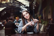Portrait of young beautiful woman drinking coffee in the cafe