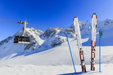 Fototapete - Winter season, ski equipments on ski run