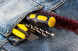Tools, screwdriver, screw, stationary knife in blue jeans jacket