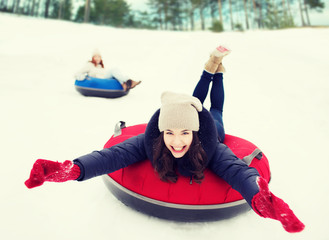 Sticker - group of happy friends sliding down on snow tubes