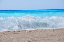Waves On A Sandy Beach And A Fairytale Blue Water