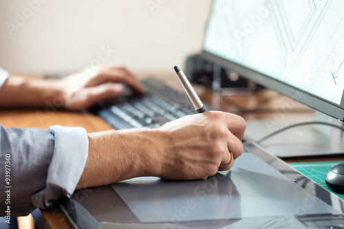 Fotografie, Obraz Graphic designer using digital tablet and computer in office or
