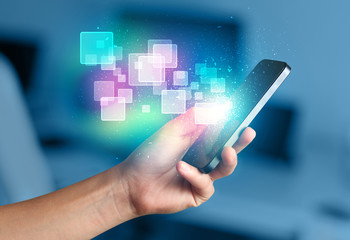 Poster - Hand holding smart phone with abstract glowing squares