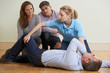 Woman Demonstrating Recovery Position In First Aid Training Clas