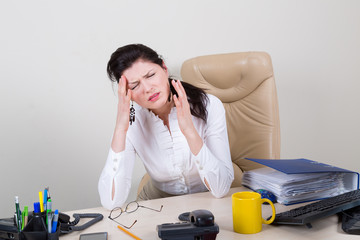 overworked woman with pain in office