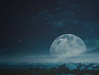 foggy night with beauty moon over snowy mountains. nasa imagery used