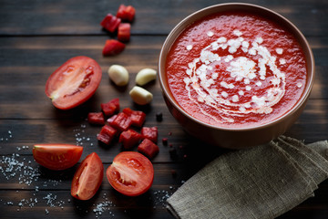 Wall Mural - Bowl with tomato soup gazpacho, rustic wooden background