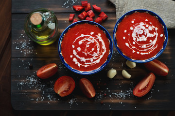 Wall Mural - Gazpacho soup on a dark rustic wooden surface, closeup, top view