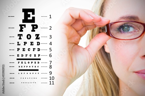 Fotografía Composite image of pretty blonde with red reading glasses