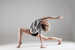 © julenochek - young beautiful woman in grey T-shirt and black shorts dancing