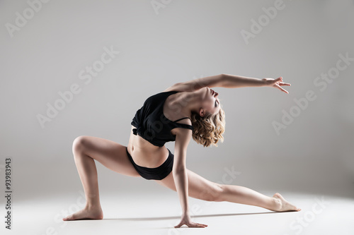 young beautiful woman in black T-shirt and shorts dancing Plakát