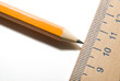 Pencil and wooden ruler on over white