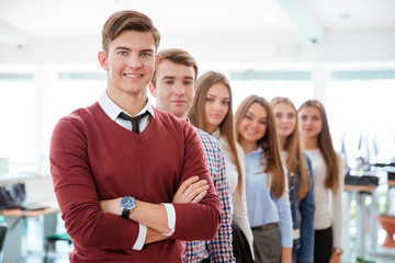 Poster - Smiling student standing in a line at universit