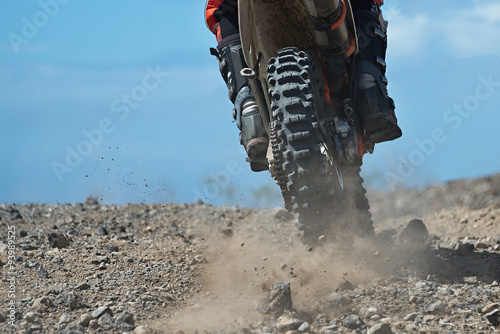 Photographie  motocross racer accelerating in dirt track