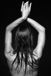 © Serg Zastavkin - Woman from back side on black background