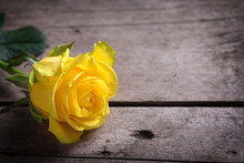 Background With Yellow Rose On Wooden Table