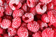Frozen ripe raspberries background
