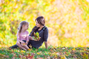 Wall Mural - Happy mother with little daughter on beautiful autumn day