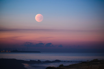 sunset moon rose over the mediterranean sea. limassol. cyprus.