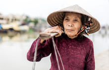 Old Friendly Woman With Vietnamese Straw Hat