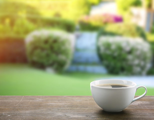 Poster - Cup of coffee on table on bright background