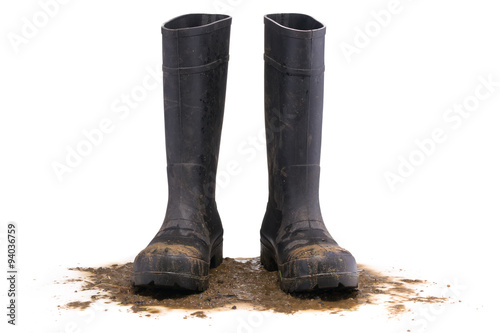 Cuadros en Lienzo Muddy rubber boots front view isolated on white background