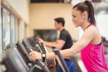 Wall Mural - Fit people working out using machines