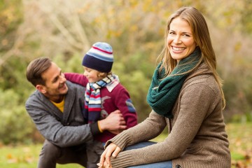 Wall Mural - Smiling young couple with little boy posing