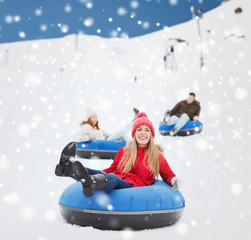 Sticker - group of happy friends sliding down on snow tubes