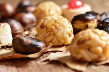 Wall Mural - roasted chestnuts and panellets, typical snack in All Saints Day