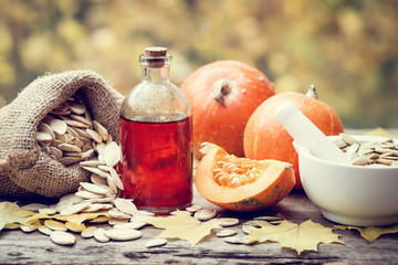 Wall Mural - pumpkin seeds oil bottle, pumpkins, canvas bag with seeds and mo