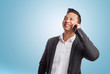 © asierromero - young asian business man talking on mobile