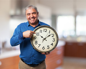 man holding a clock