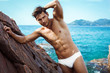 Sexy man in underwear posing on sea scenery